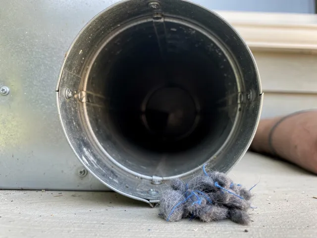 Dana Point Dryer Vent Cleaning technician using specialized equipment to clear severe dryer vent blockage in Dana Point